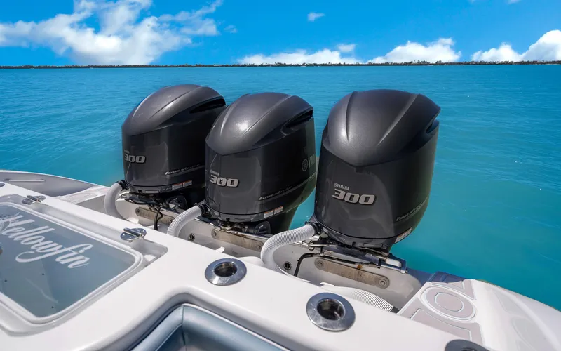 Slide: The Image of 2019 Yellowfin 36 boat with triple 300 horsepower engines on clear blue water. - 28