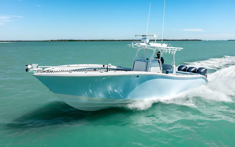 Slide: The Image of 2019 Yellowfin 36 boat cruising on turquoise water under clear blue sky. - 3
