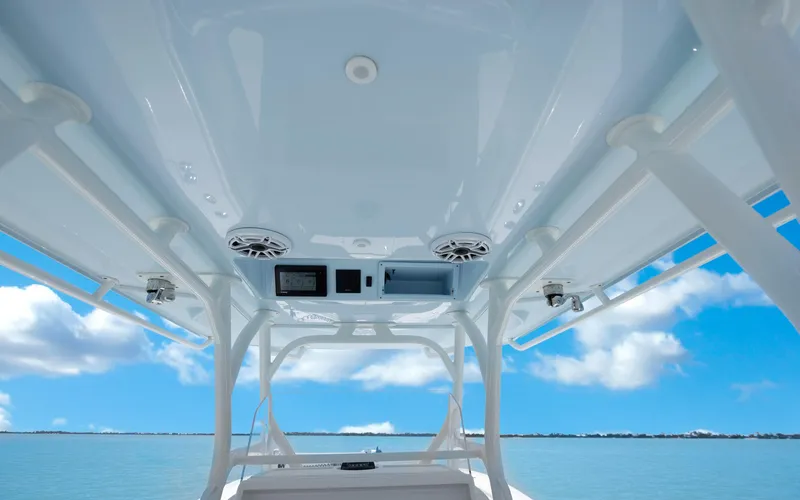 Slide: The Image of 2019 Yellowfin 36 boat interior with speakers and electronics, under a clear blue sky. - 33