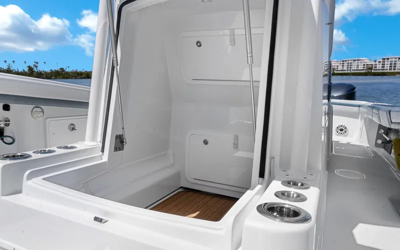 Slide: The Image of 2019 Yellowfin 36 boat interior with open storage compartment and cup holders. - 35