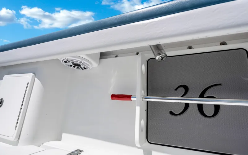 Slide: The Image of 2019 Yellowfin 36 boat interior with speaker and storage compartment under blue sky. - 36