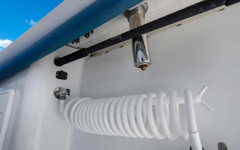 Slide: The Image of 2019 Yellowfin 36 boat detail with coiled hose and faucet. - 37