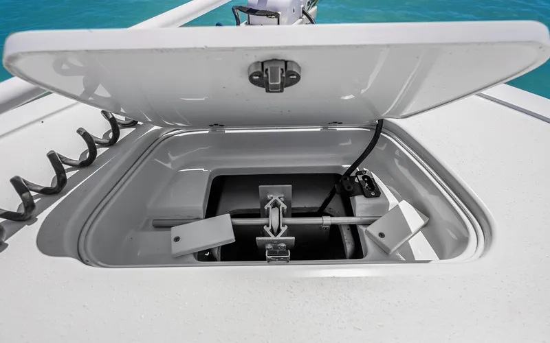 Slide: The Image of Open anchor compartment on 2019 Yellowfin 36 boat, showing storage and mechanism. - 38