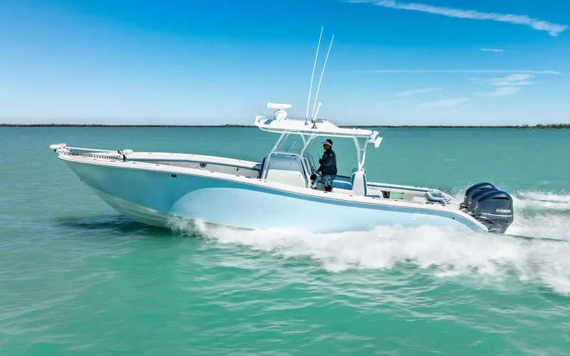Slide: The Image of 2019 Yellowfin 36 boat cruising on turquoise water under clear blue sky. - 5