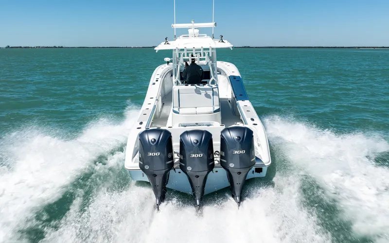 Slide: The Image of 2019 Yellowfin 36 boat with triple 300 horsepower engines cruising on open water. - 7