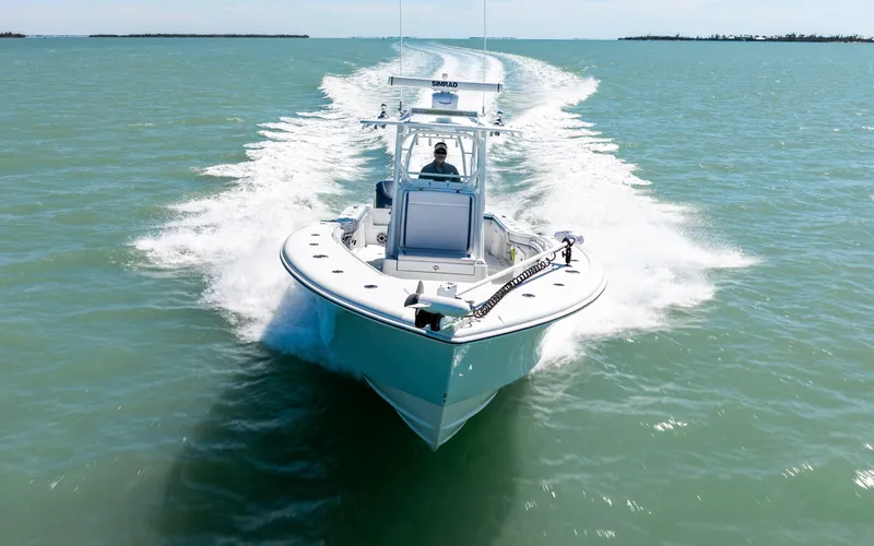 Slide: The Image of 2019 Yellowfin 36 boat cruising on open water, creating a dynamic wake. - 8