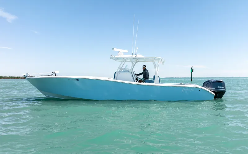 Slide: The Image of 2019 Yellowfin 36 boat on calm turquoise water under clear blue sky. - 9