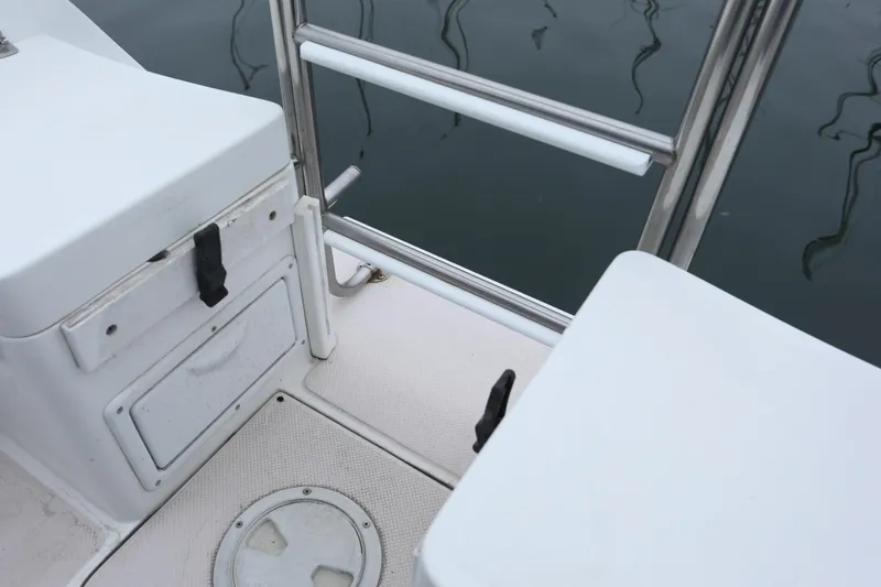 Slide: The Image of Interior of a 1995 Catalina 30 yacht, featuring white seating areas. - 11