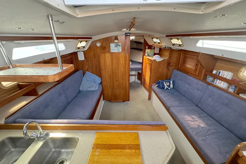 Slide: The Image of Interior of a 1995 Catalina 30 yacht with blue upholstery. - 17