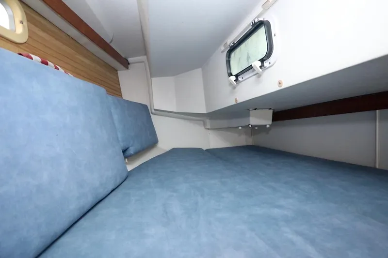 Slide: The Image of Interior of a 1995 Catalina 30 yacht with blue cushions. - 18