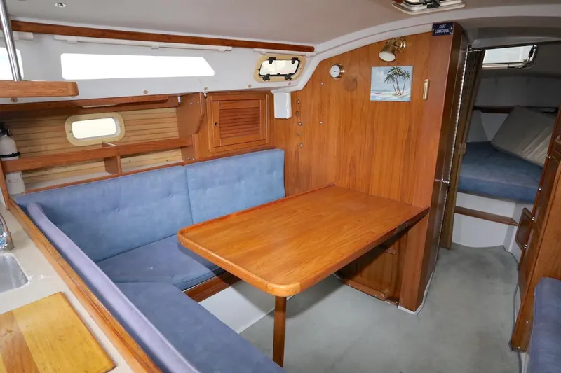 Slide: The Image of Interior of a 1995 Catalina 30 yacht with wooden table and blue upholstery. - 23