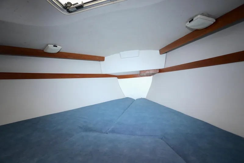 Slide: The Image of Interior of a 1995 Catalina 30 yacht with blue upholstery. - 28