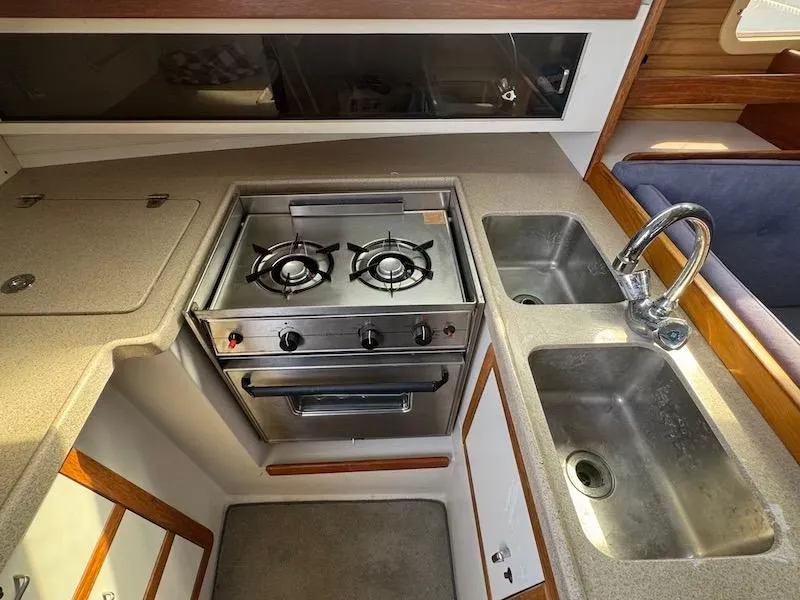 Slide: The Image of 1995 Catalina 30 kitchen area with stove and sink. - 35