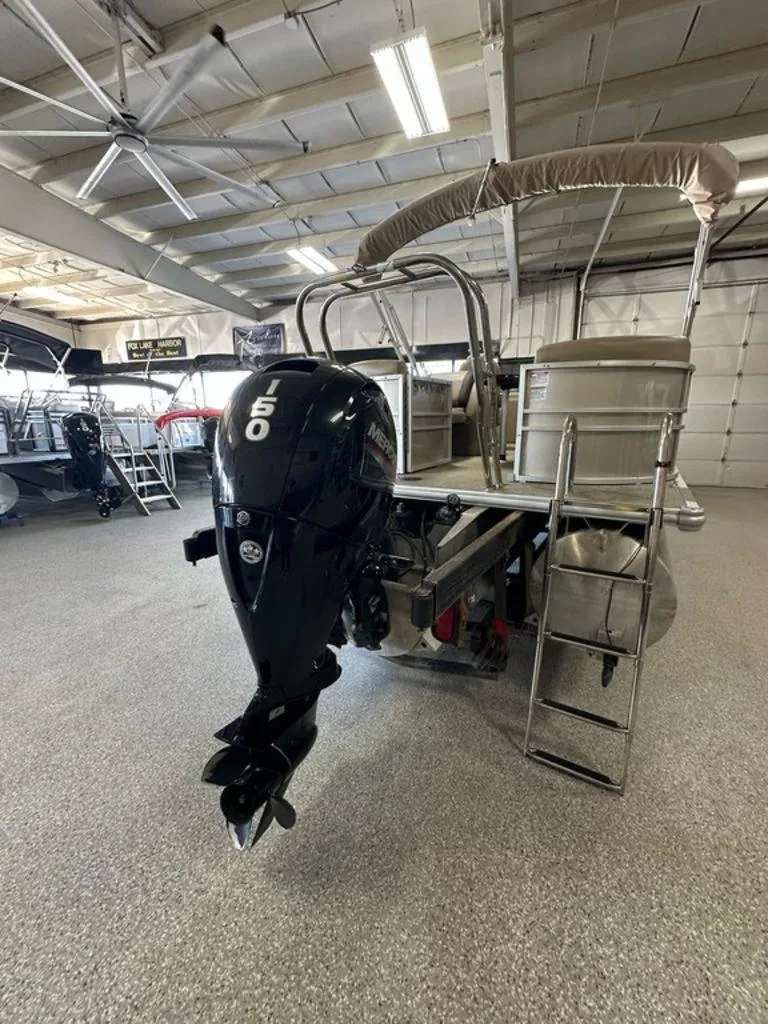 Slide: The Image of 2022 Sylvan 8522 Mirage LZ pontoon boat with 150 HP engine in showroom. - 13