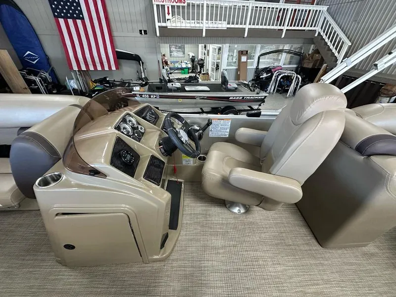 Slide: The Image of 2022 Sylvan 8522 Mirage LZ boat interior with steering console and captain's chair. - 7