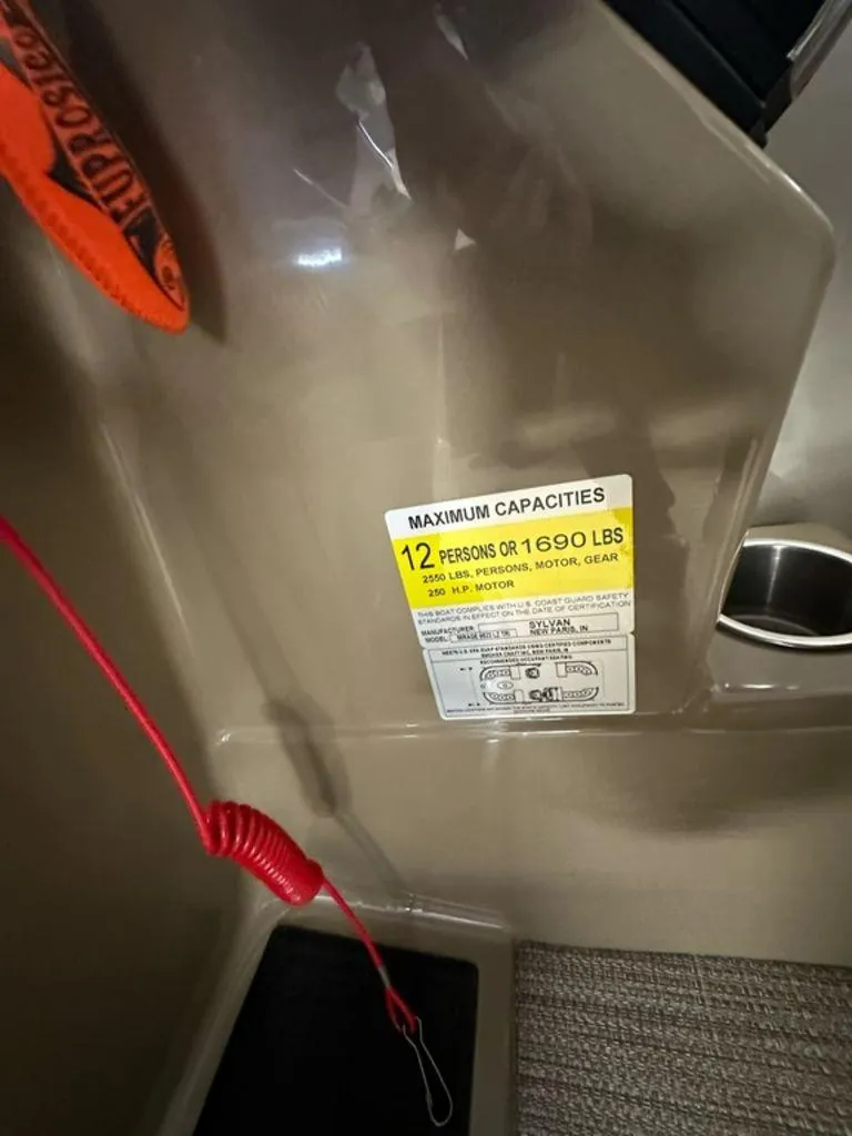 Slide: The Image of 2022 Sylvan 8522 Mirage LZ capacity label, 12 persons or 1690 lbs, 250 HP motor. - 9