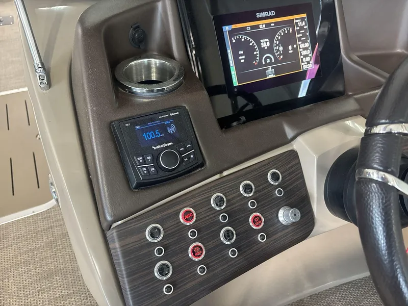 Slide: The Image of 2022 Bennington 25QXSBWA dashboard with Simrad display and Rockford Fosgate audio controls. - 10