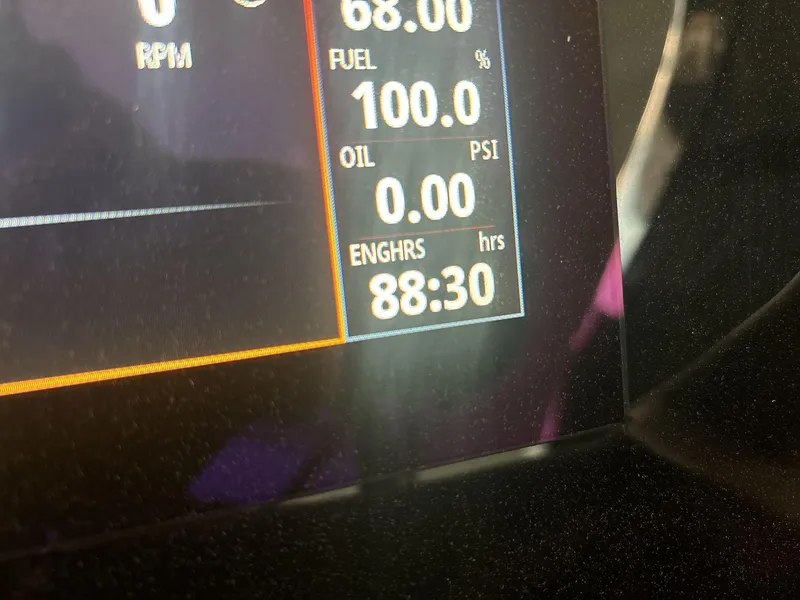 Slide: The Image of Dashboard display of a 2022 Bennington 25QXSBWA showing fuel, oil, and engine hours. - 11