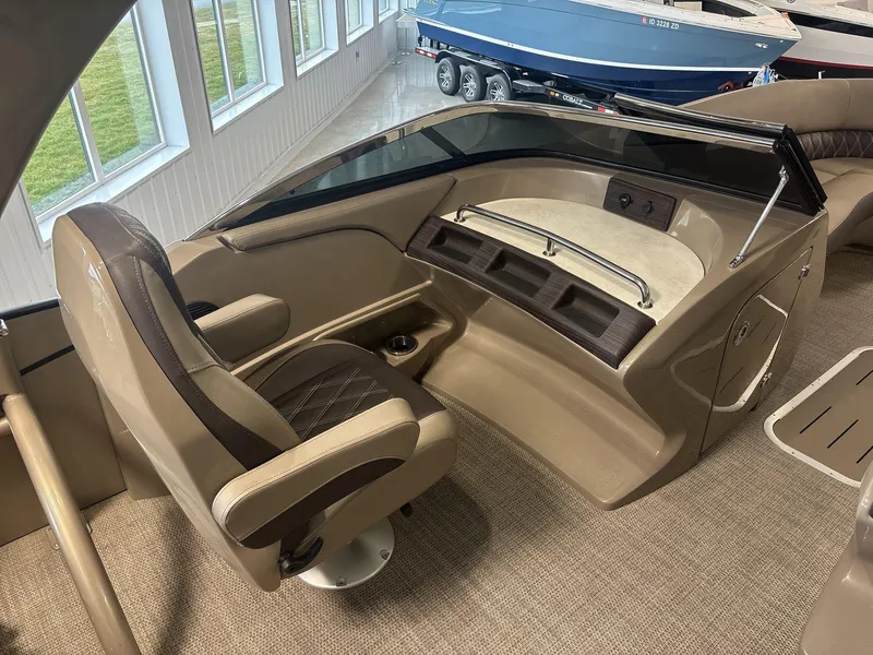 Slide: The Image of Captain's seat and helm of 2022 Bennington 25QXSBWA boat, featuring luxurious interior design. - 7