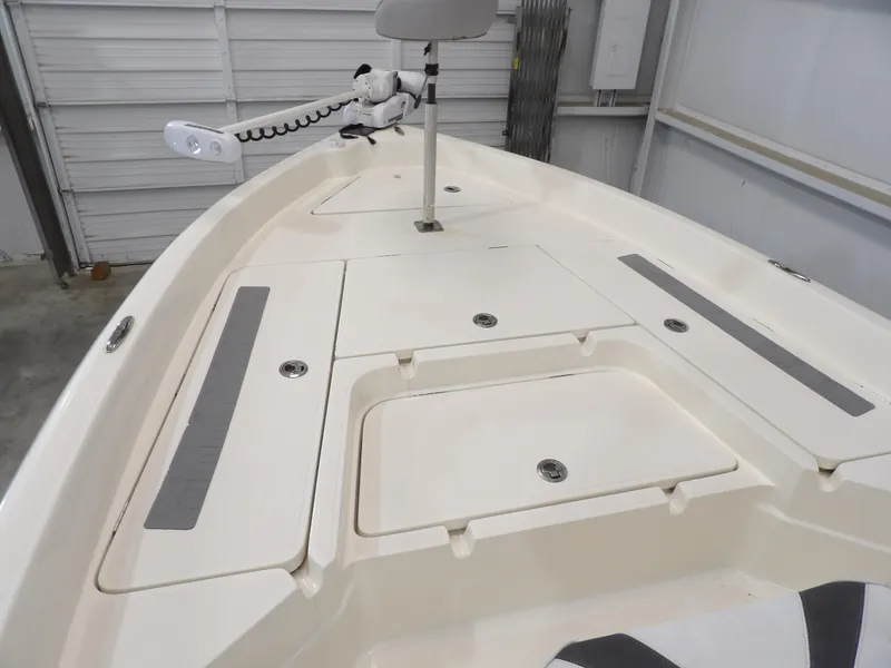 Slide: The Image of 2018 Skeeter SX2250 boat deck with storage compartments and trolling motor. - 10