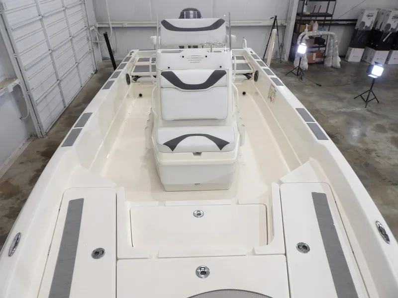Slide: The Image of 2018 Skeeter SX2250 boat interior with white seating in a garage setting. - 11