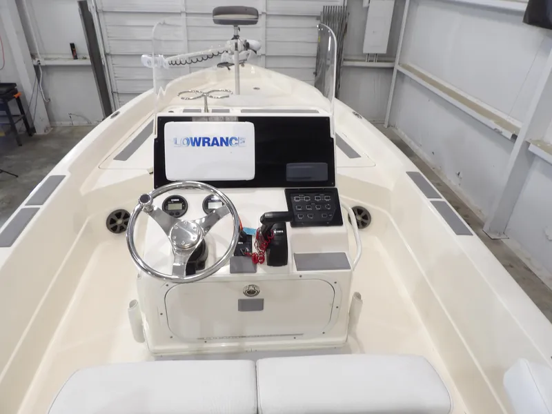 Slide: The Image of 2018 Skeeter SX2250 boat console with Lowrance electronics in a garage setting. - 13