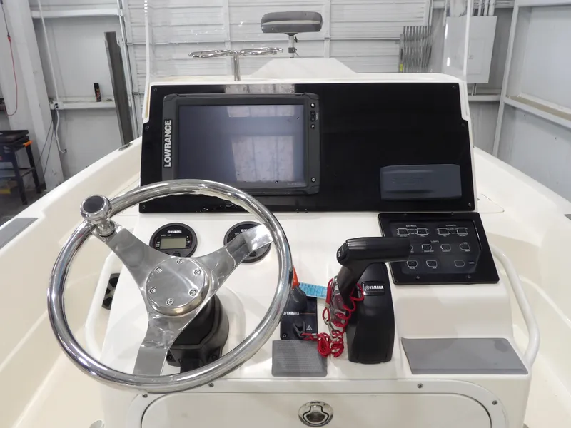 Slide: The Image of 2018 Skeeter SX2250 boat console with steering wheel, Lowrance display, and Yamaha controls. - 14