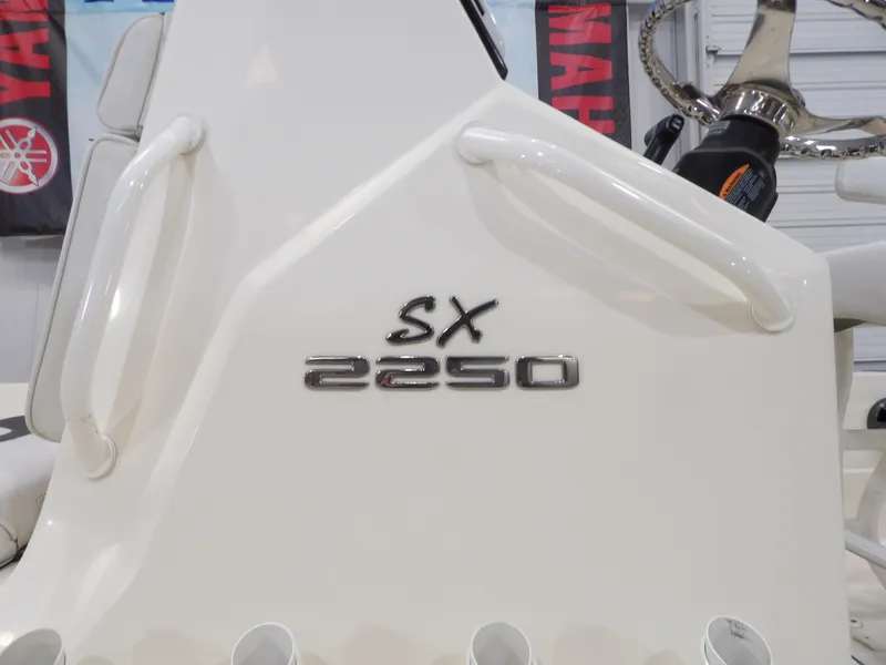 Slide: The Image of 2018 Skeeter SX2250 boat console with steering wheel and model emblem. - 6