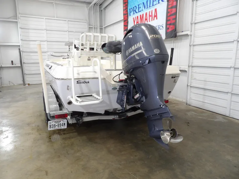 Slide: The Image of 2018 Skeeter SX2250 boat with Yamaha 200 outboard motor in a garage. - 7