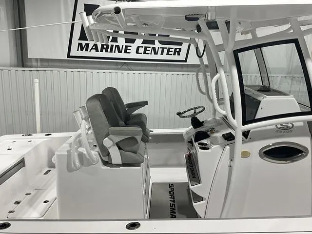 Slide: The Image of 2020 Sportsman Masters 267OE boat interior with helm and seating at marine center. - 10