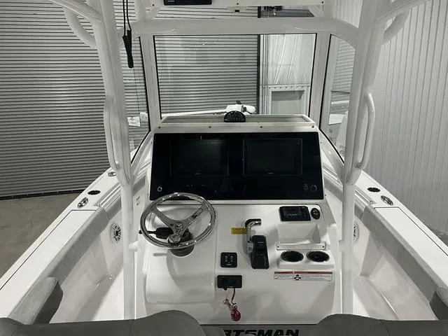 Slide: The Image of 2020 Sportsman Masters 267OE boat console with steering wheel and electronic displays. - 11