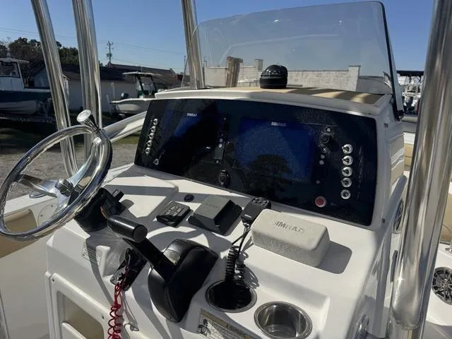 Slide: The Image of 2017 Sportsman Heritage 211 boat dashboard with steering wheel and navigation controls. - 5