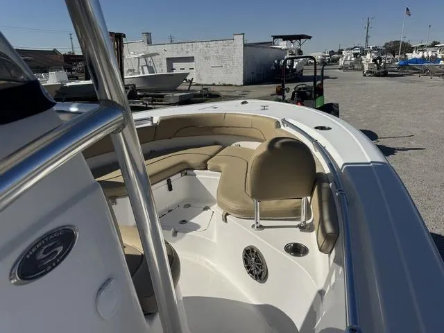 Slide: The Image of 2017 Sportsman Heritage 211 boat with beige seating, docked in a marina. - 7
