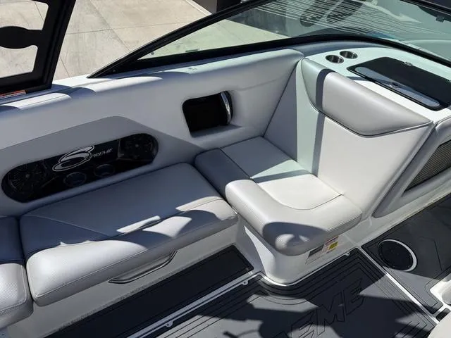 Slide: The Image of Interior of a 2015 Supreme S226 boat with gray seating and cup holders. - 11