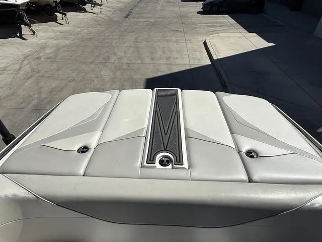 Slide: The Image of Rear deck of a 2015 Supreme S226 boat in a marina setting. - 12