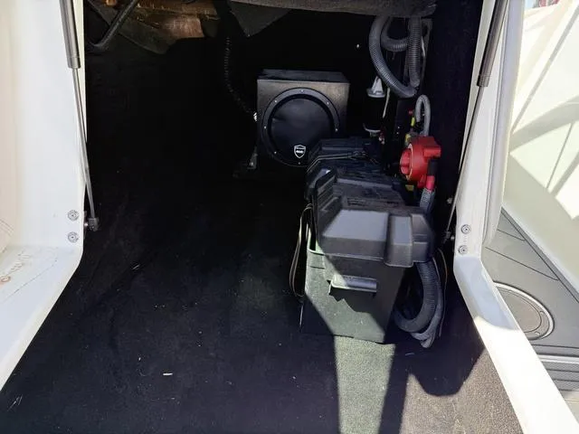 Slide: The Image of Interior view of a 2015 Supreme S226 boat compartment with battery and wiring. - 13