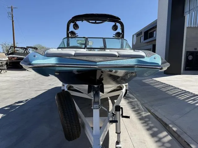 Slide: The Image of 2015 Supreme S226 boat on trailer, front view, parked outdoors. - 3
