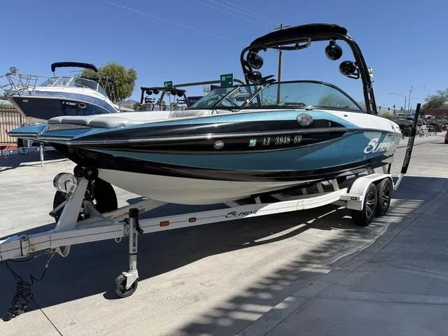 Slide: The Image of 2015 Supreme S226 boat on trailer, sleek design, parked outdoors. - 4