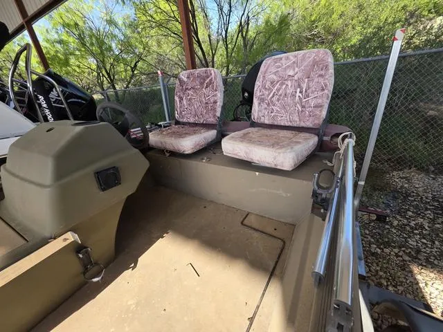 Slide: The Image of 2012 Tracker 1648 boat interior with two camo seats and steering console. - 3