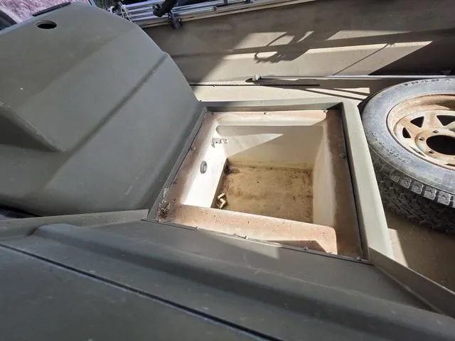 Slide: The Image of 2012 Tracker 1648 boat interior with storage compartment and spare tire. - 9