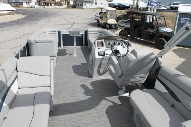 Slide: The Image of 2023 Bennington 21 SSR pontoon boat interior with gray seating and steering console. - 5