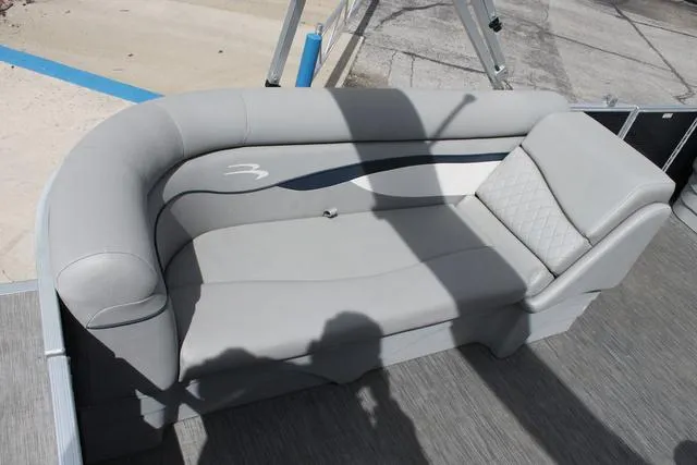 Slide: The Image of 2023 Bennington 21 SSR boat interior with gray cushioned seating. - 7