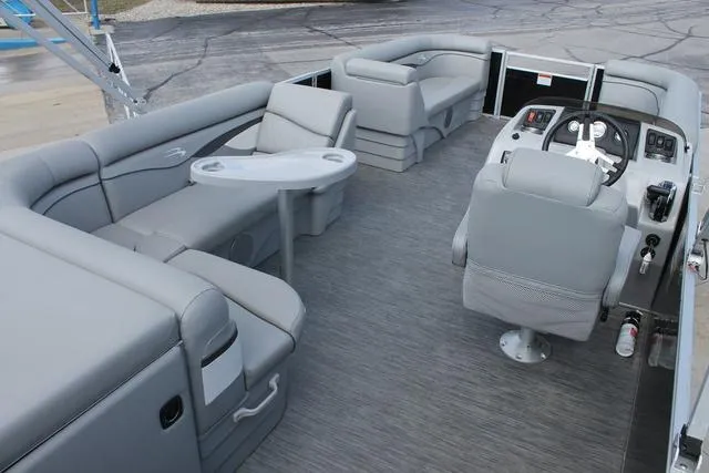 Slide: The Image of 2023 Bennington 21 SL pontoon boat interior with gray seating and helm. - 5