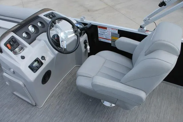 Slide: The Image of 2023 Bennington 21 SL boat interior with steering wheel and captain's chair. - 8