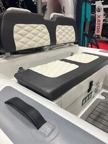 Slide: The Image of 2025 Highfield SP360 boat interior with cushioned seating and modern steering console. - 3