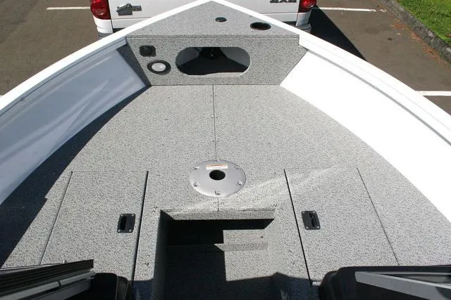 Slide: The Image of 2023 Crestliner 1700 Vision boat deck with gray textured surface and storage compartments. - 10