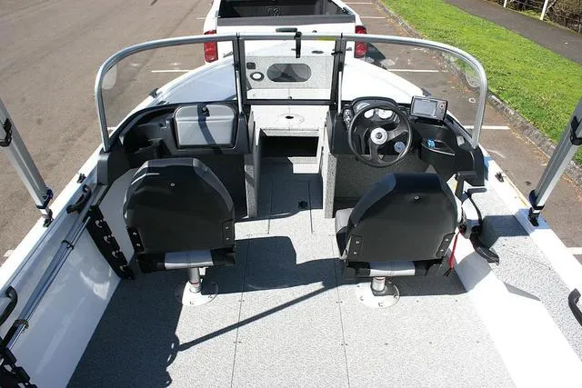 Slide: The Image of 2023 Crestliner 1700 Vision boat interior with dual seats and steering console. - 5