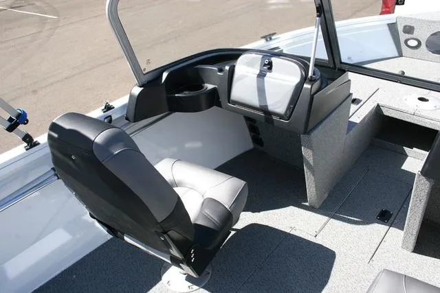 Slide: The Image of 2023 Crestliner 1700 Vision boat interior with seating and dashboard. - 7