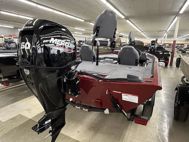 Slide: The Image of 2025 Lowe Stinger 175C boat with Mercury 60 engine displayed indoors. - 10