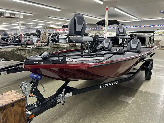 Slide: The Image of 2025 Lowe Stinger 175C fishing boat on display in showroom, featuring Minn Kota trolling motor. - 2